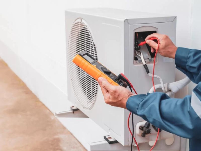 Technician testing an outdoor unit